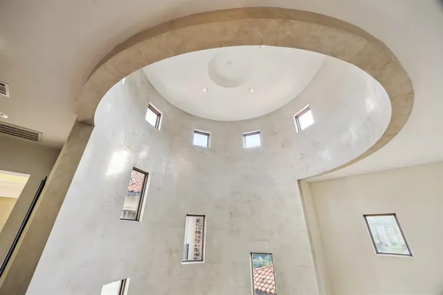 a dining room with furniture a chandelier and window