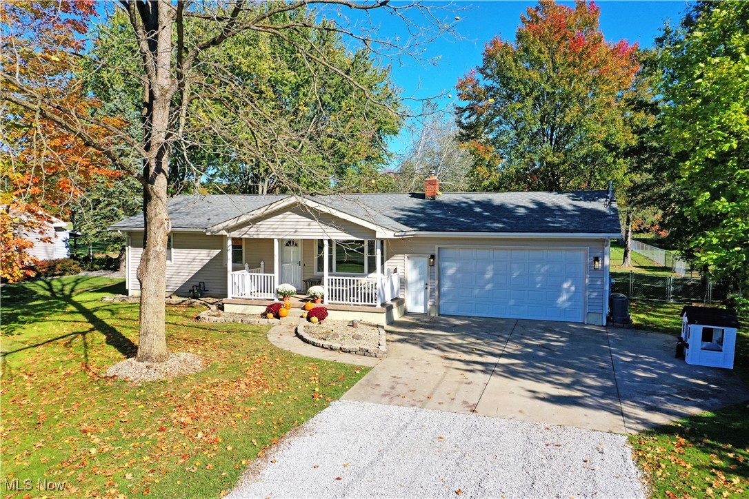 4400 Ridge Road Cortland, OH 44410 - Photo 1 of 50 Single story home featuring concrete driveway, covered porch, an attached garage, and a chimney