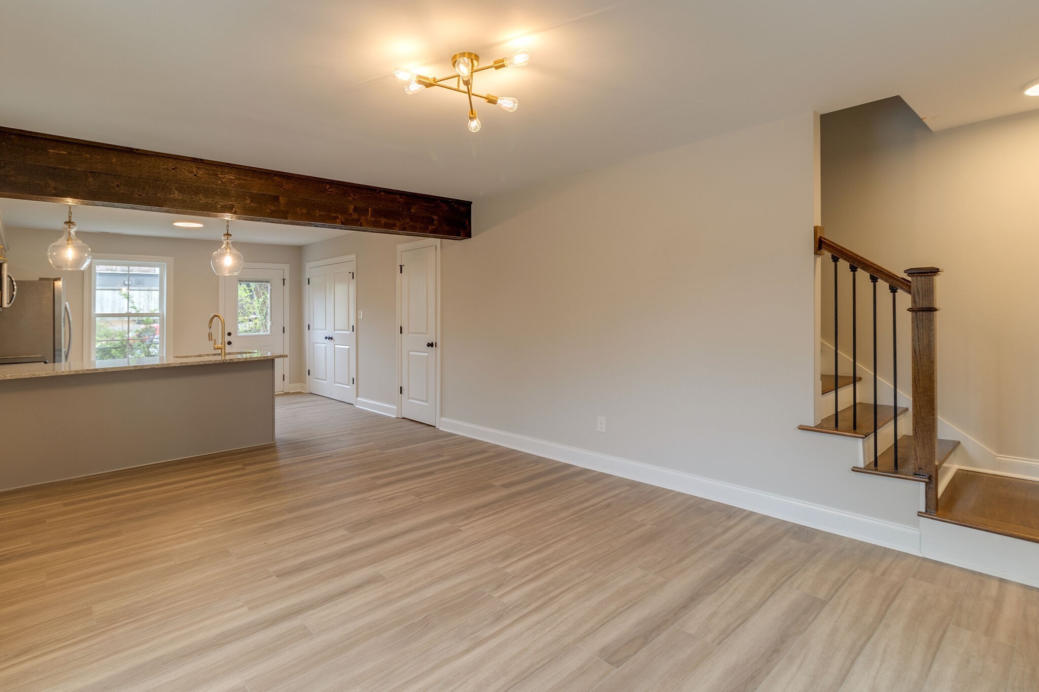 1008 Beckett Street, Unit A Columbia, TN 38401 - Photo 16 of 29 an empty room with wooden floor and a hallway