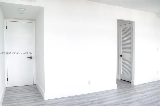 a view of a room with wooden floor