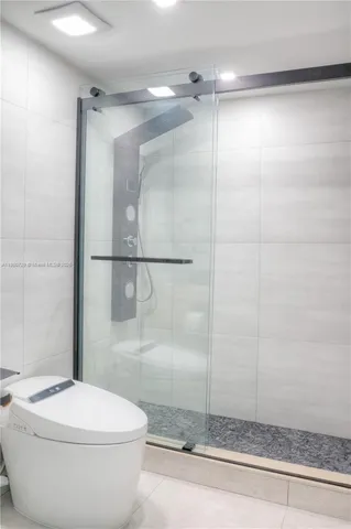 a bathroom with a toilet and a shower