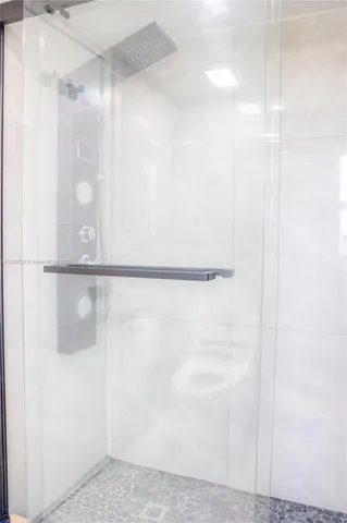 a bathroom with a glass shower door