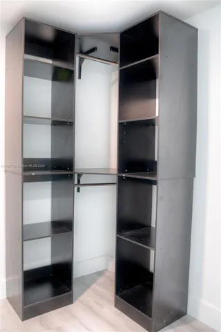 a view of walk in closet with empty racks