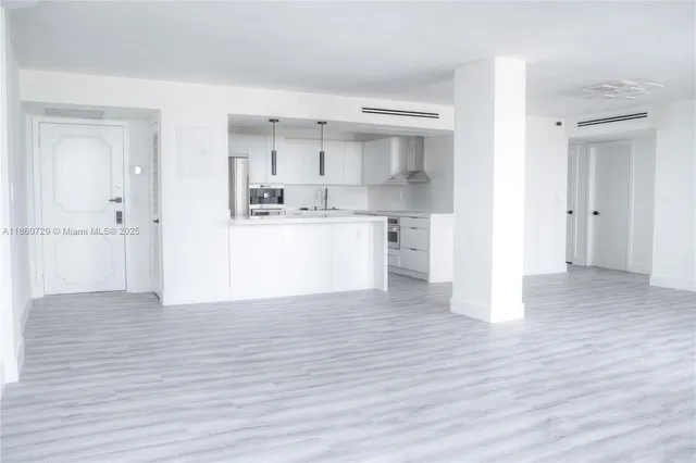 a view of a kitchen with wooden floor and a sink