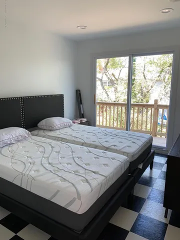 a bedroom with a bed next to a window