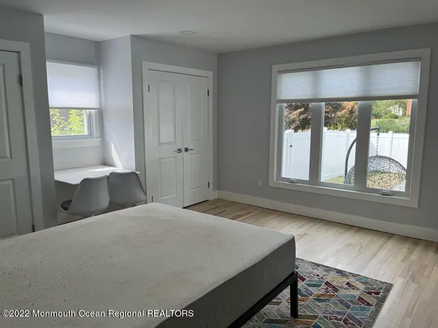 a bedroom with a bed and a large window