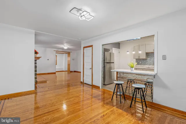 a view of a livingroom with furniture and a kitchen view