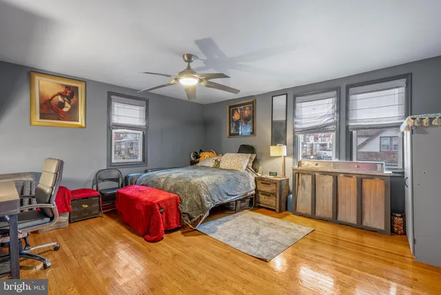 a bedroom with 2 bed and a chandelier