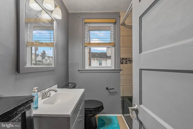 a bathroom with a sink toilet and tub