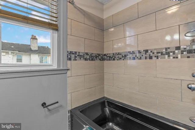 a bathroom with a bathtub and shower