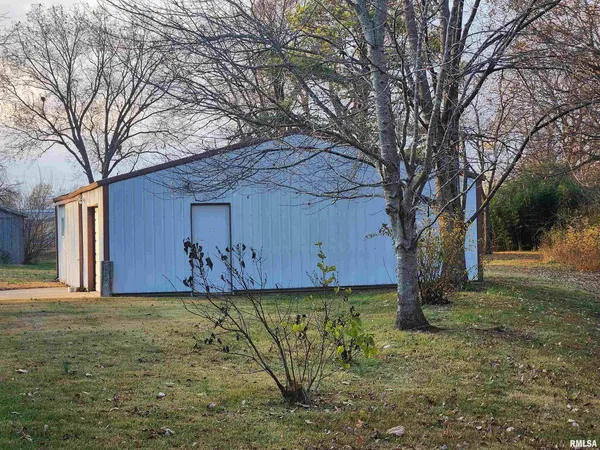 a view of a yard with large trees