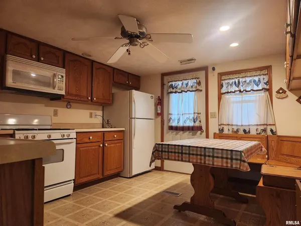 a kitchen with stainless steel appliances granite countertop a refrigerator a sink a stove and island