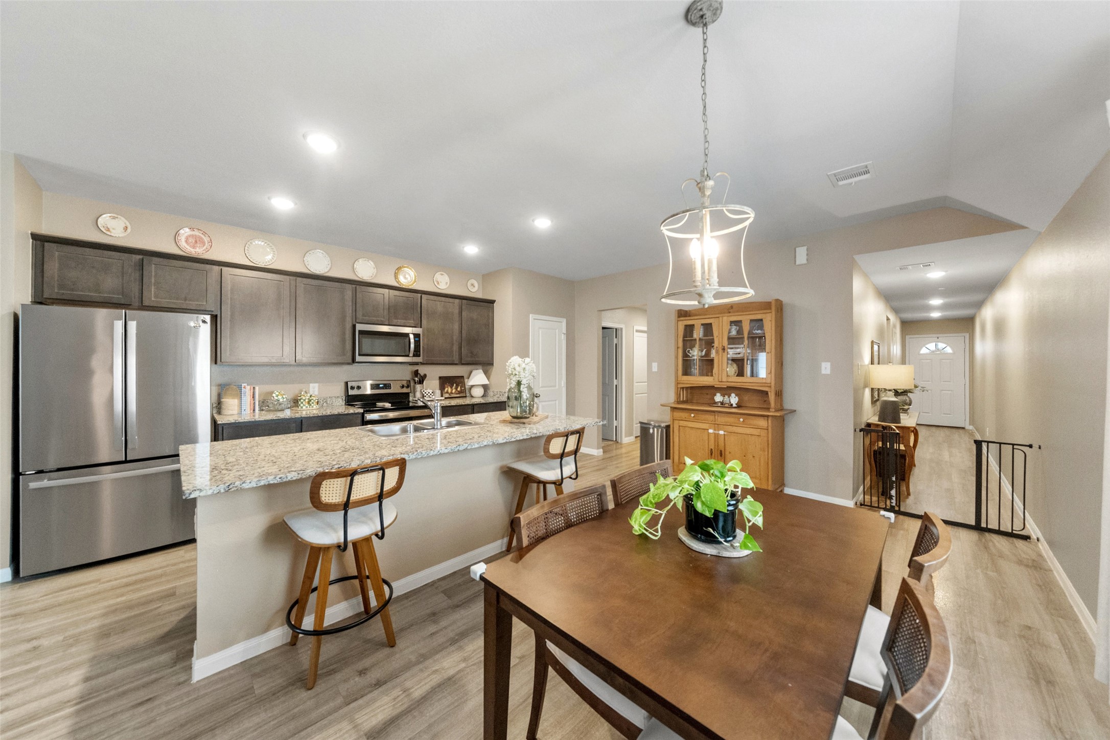 26431 Pin Oak Drive Hempstead, TX 77445 - Photo 32 of 32 Another view of the spacious kitchen showcases the oversized island, generous counter space, and ample cabinetry for storage. The open floorplan keeps everyone connected across living, dining, and kitchen areas.