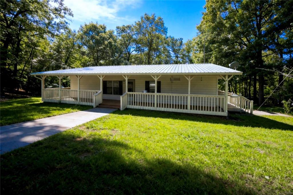 a view of a backyard with a garden and deck