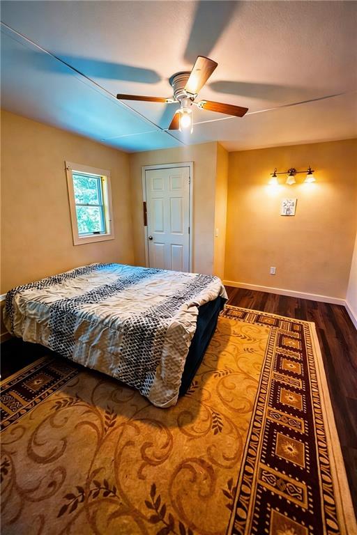 180 Alonzo Cain Road Dahlonega, GA 30533 - Photo 18 of 28 a bedroom with a bed and wooden floor