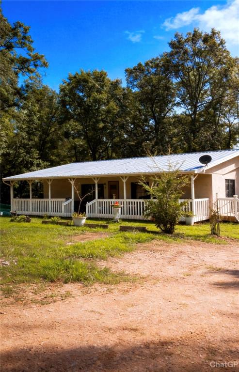 180 Alonzo Cain Road Dahlonega, GA 30533 - Photo 3 of 28 a front view of a house with a yard table and chairs