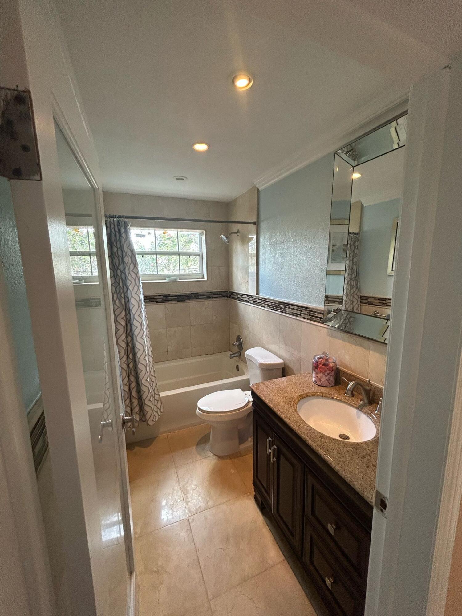 5200 Adams Street Hollywood, FL 33021 - Photo 11 of 24 a bathroom with a double vanity sink toilet and shower