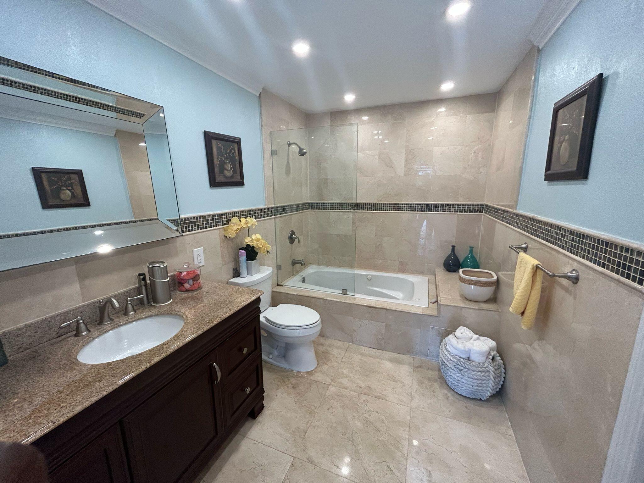 5200 Adams Street Hollywood, FL 33021 - Photo 13 of 24 a bathroom with a granite countertop sink mirror and bathtub