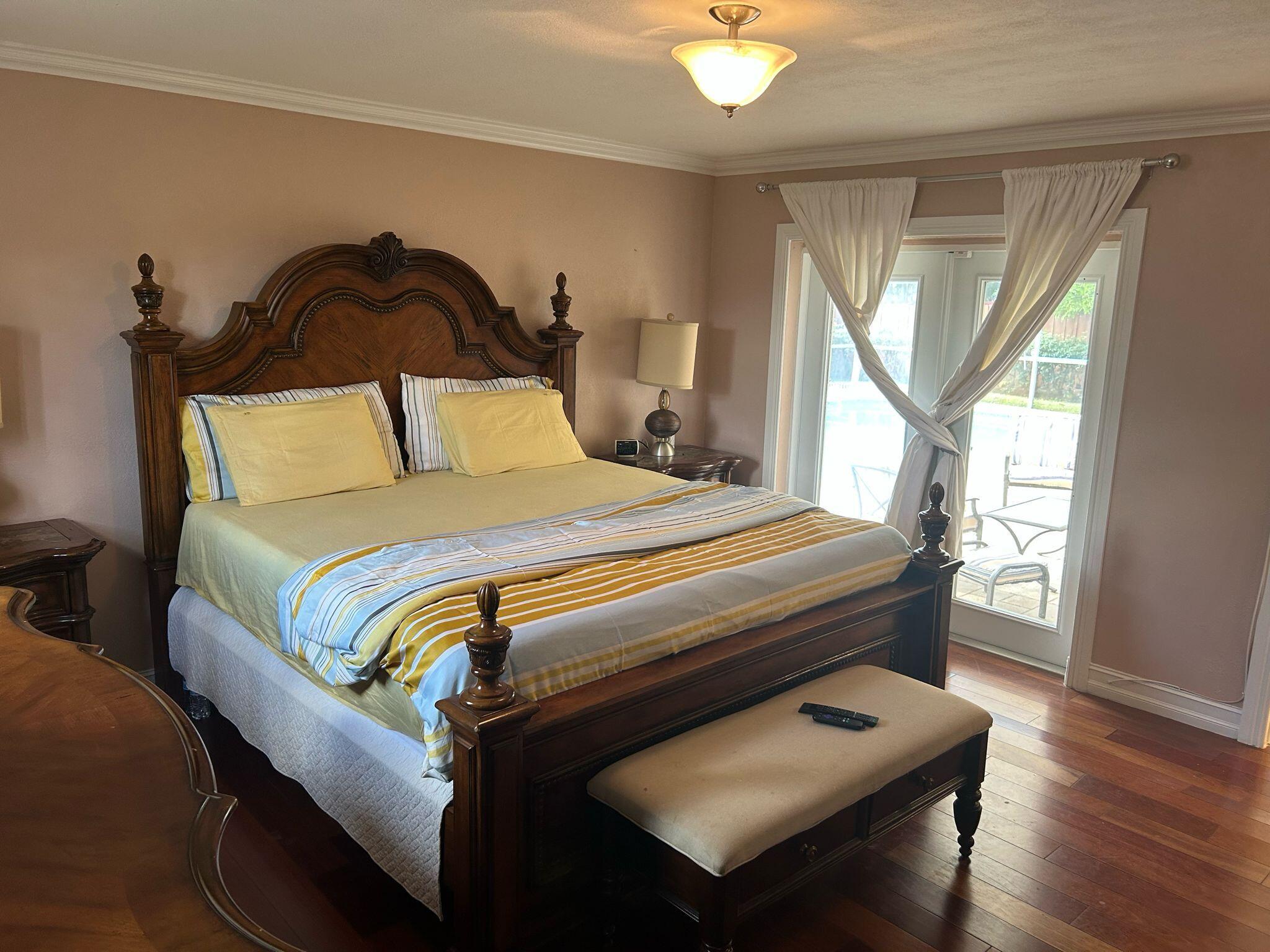 5200 Adams Street Hollywood, FL 33021 - Photo 15 of 24 a bedroom with a bed and wooden floor