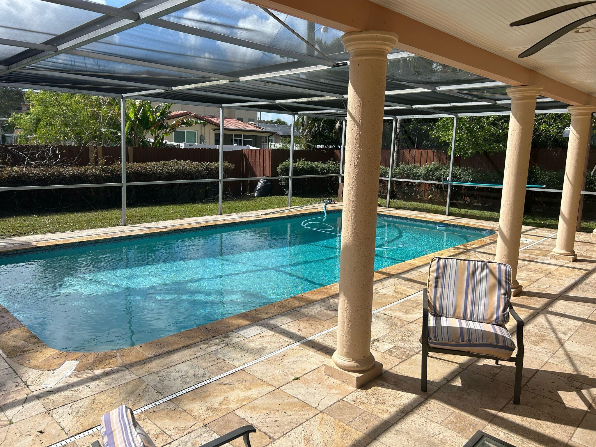5200 Adams Street Hollywood, FL 33021 - Photo 16 of 24 a view of a swimming pool with porch and patio