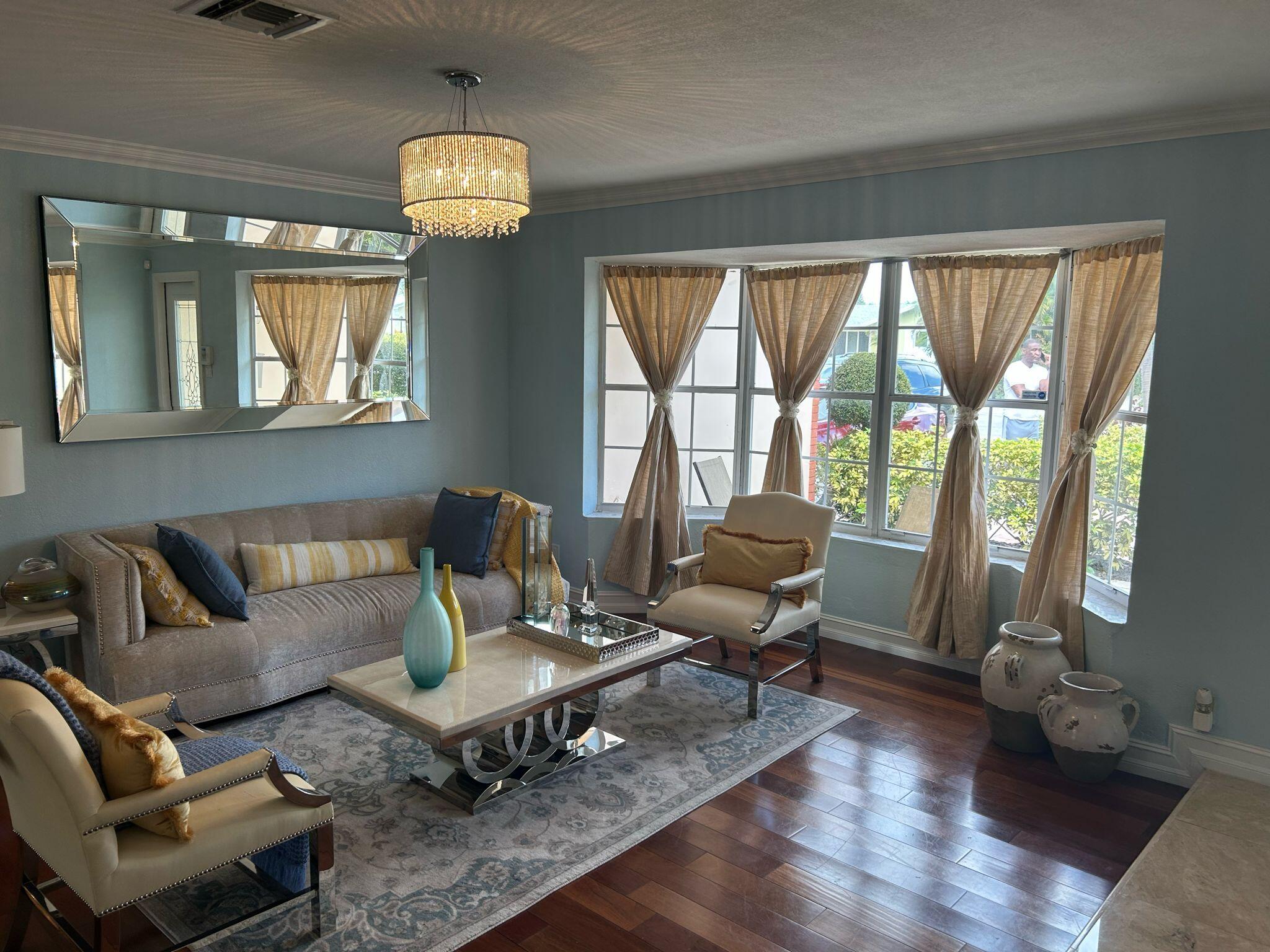 5200 Adams Street Hollywood, FL 33021 - Photo 2 of 24 a living room with furniture a table and large windows