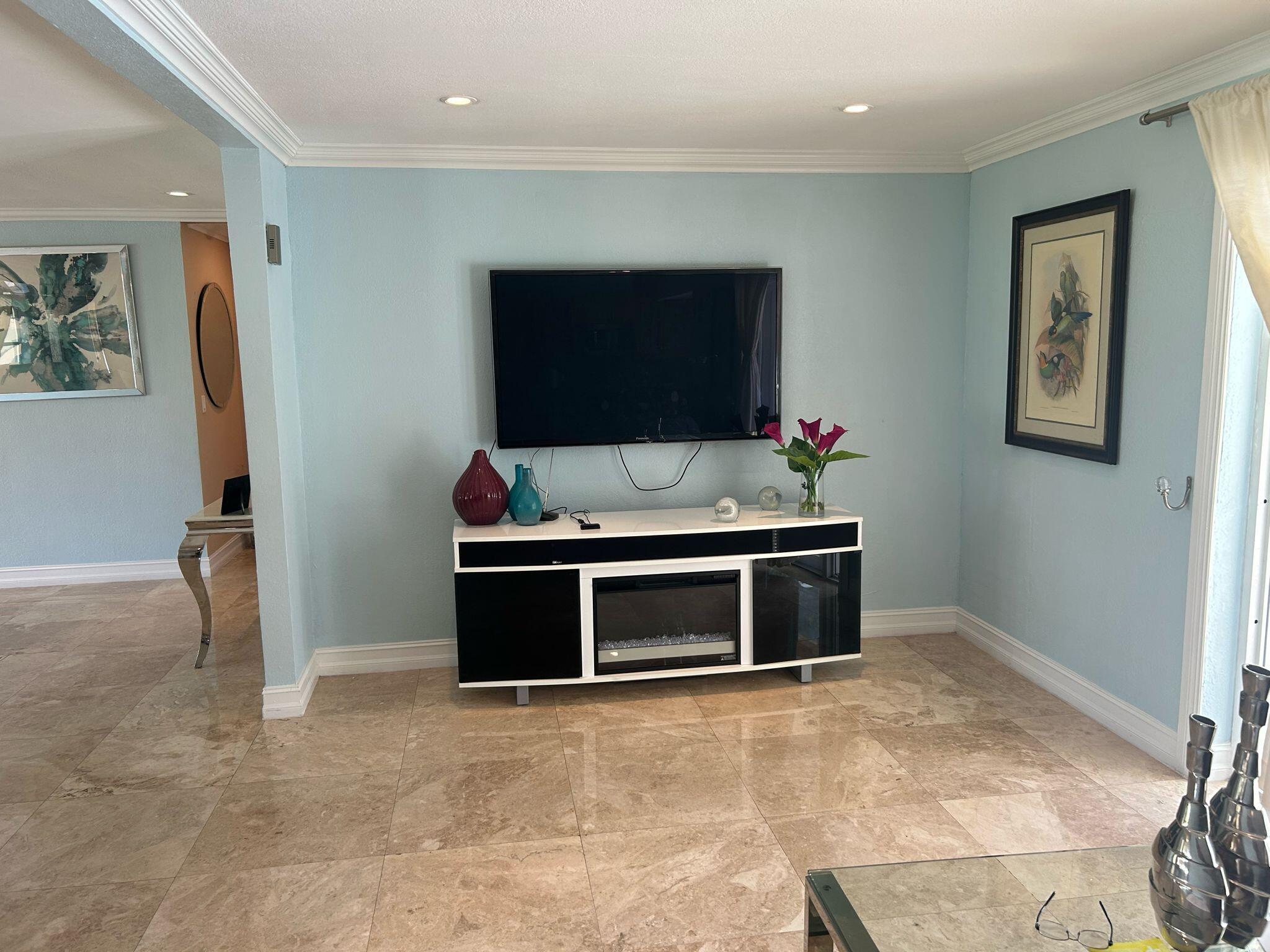5200 Adams Street Hollywood, FL 33021 - Photo 22 of 24 a room with furniture and a flat screen tv
