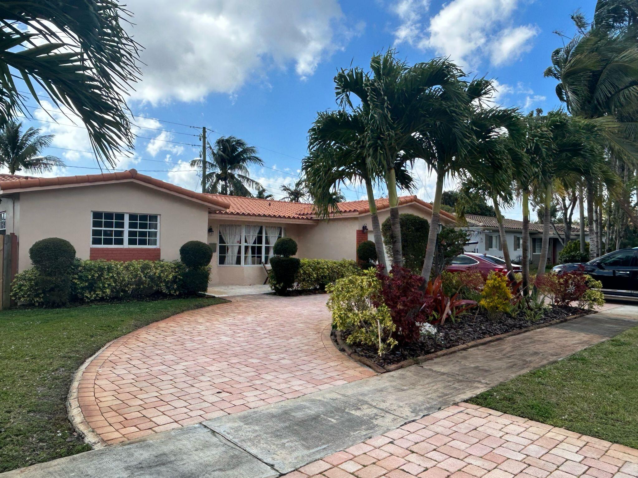 5200 Adams Street Hollywood, FL 33021 - Photo 24 of 24 a front view of a house with garden