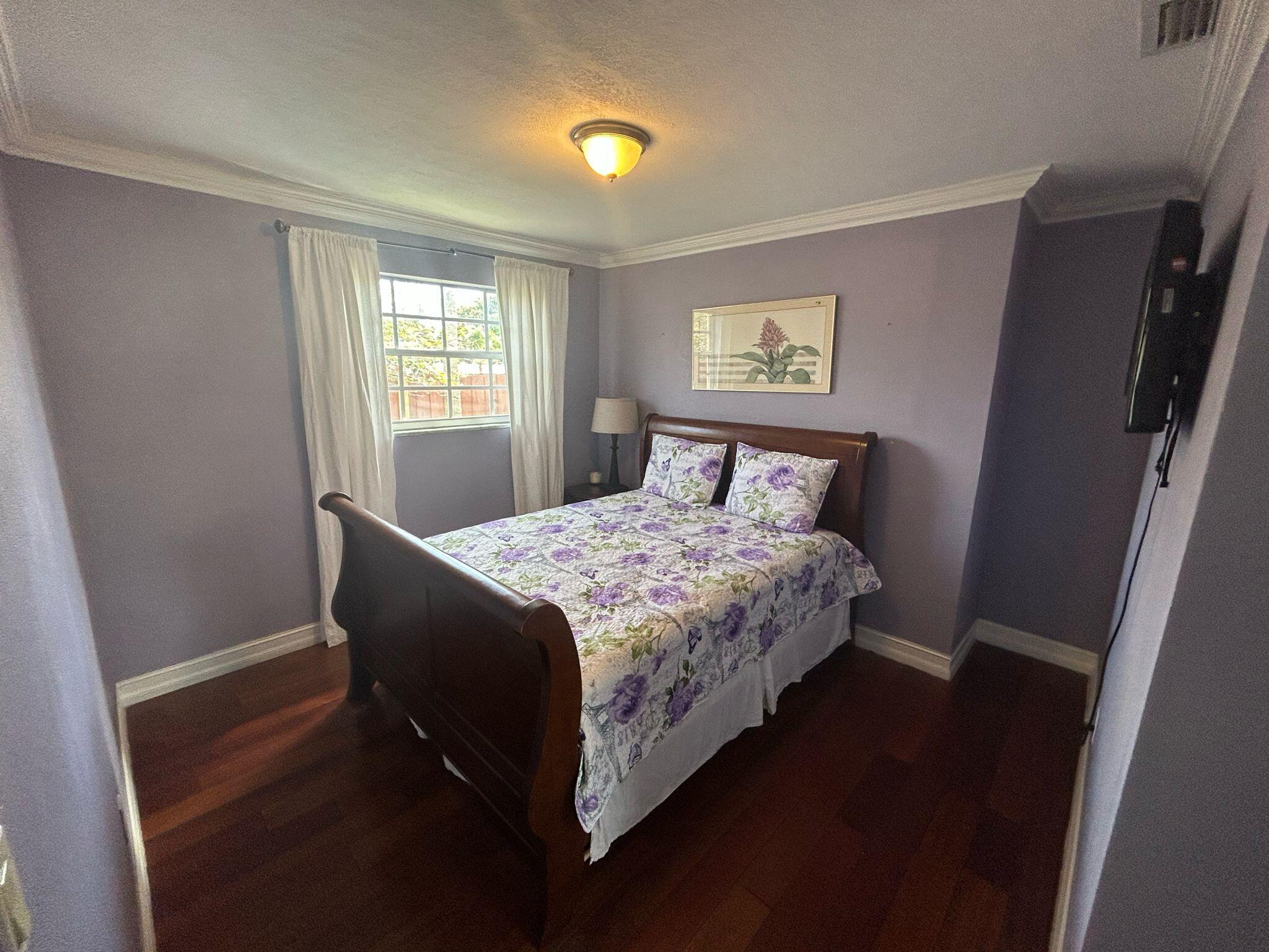 5200 Adams Street Hollywood, FL 33021 - Photo 7 of 24 a bedroom with a bed and window