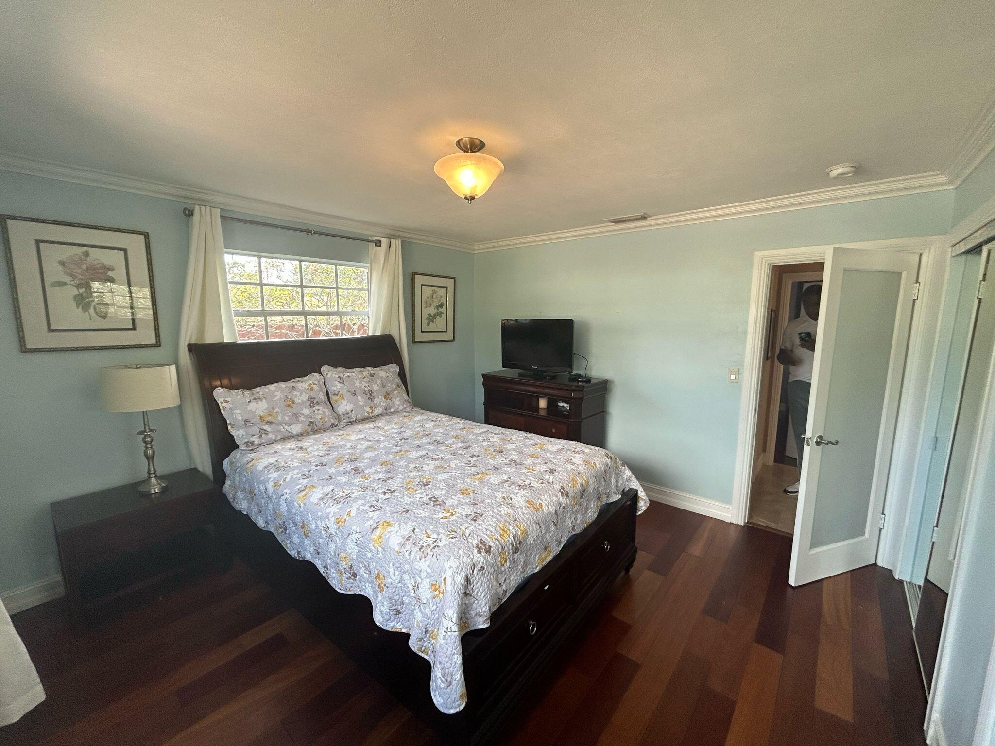 5200 Adams Street Hollywood, FL 33021 - Photo 9 of 24 a bedroom with a bed and wooden floor