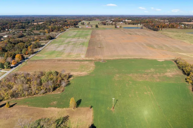 an aerial view of a houses with a yard