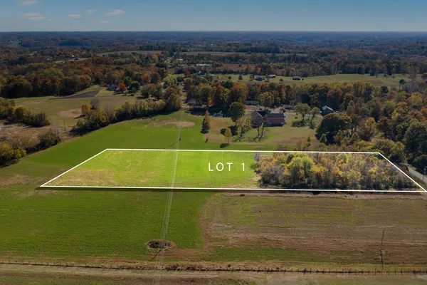 an aerial view of a golf course with a lake view