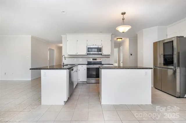 a kitchen with cabinets and stainless steel appliances