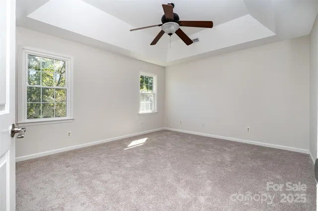 a view of room with window and ceiling fan