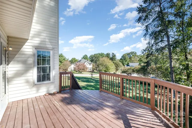 a view of a wooden deck next to a yard