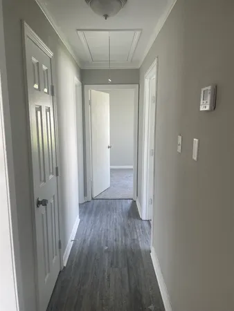 a room with white cabinets and refrigerator