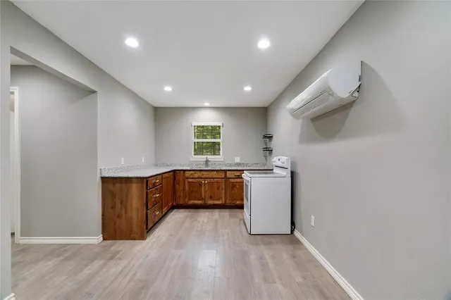 a kitchen with a wooden floor and window