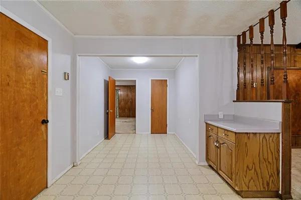 a view of a hallway with wooden shelves