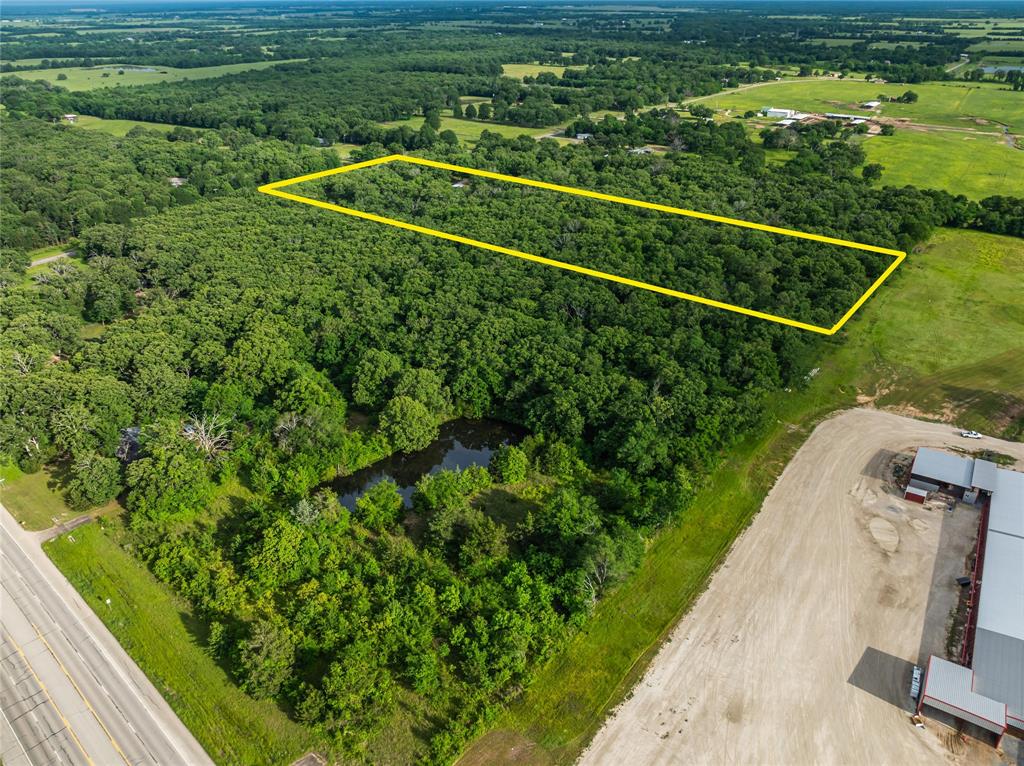 64 Farm Road 2121 Paris, TX 75462 - Photo 32 of 34 Aerial view of property's location featuring property boundaries highlighted and a heavily wooded area