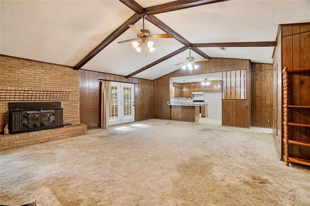 64 Farm Road 2121 Paris, TX 75462 - Photo 5 of 34 Living Room with brick, wood-burning fireplace and vaulted ceiling