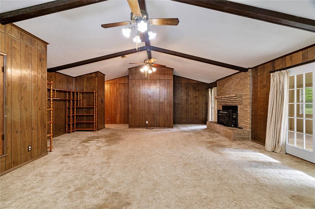 64 Farm Road 2121 Paris, TX 75462 - Photo 6 of 34 Living Room with brick, wood-burning fireplace and vaulted ceiling