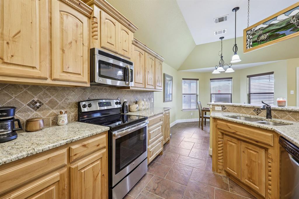 118 Kenya Court Springtown, TX 76082 - Photo 15 of 35 a kitchen with stainless steel appliances granite countertop a stove and cabinets
