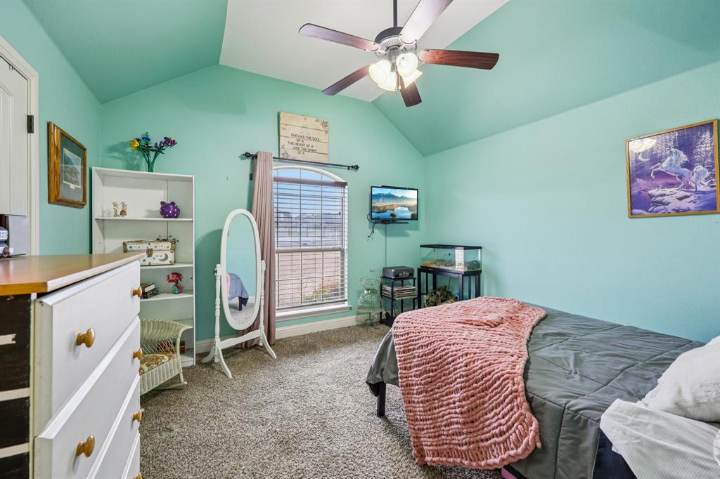 118 Kenya Court Springtown, TX 76082 - Photo 19 of 35 a bedroom with a bed and a chandelier