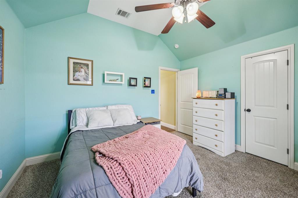 118 Kenya Court Springtown, TX 76082 - Photo 20 of 35 a bedroom with a bed and a cabinets