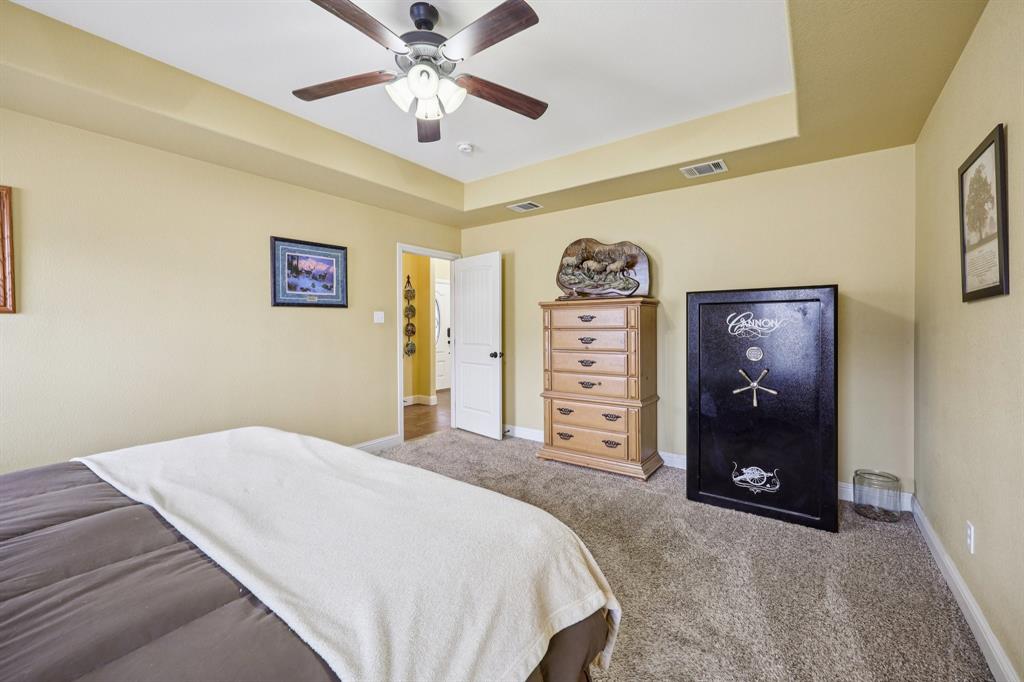118 Kenya Court Springtown, TX 76082 - Photo 25 of 35 a bedroom with a bed and a ceiling fan
