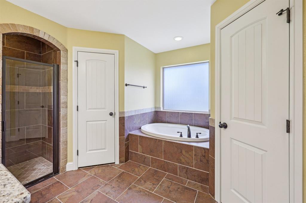 118 Kenya Court Springtown, TX 76082 - Photo 28 of 35 a bathroom with a tub and a shower