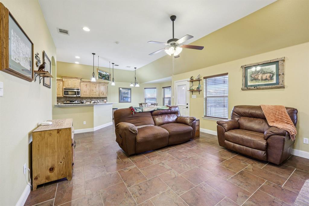 118 Kenya Court Springtown, TX 76082 - Photo 5 of 35 a living room with furniture and a chandelier