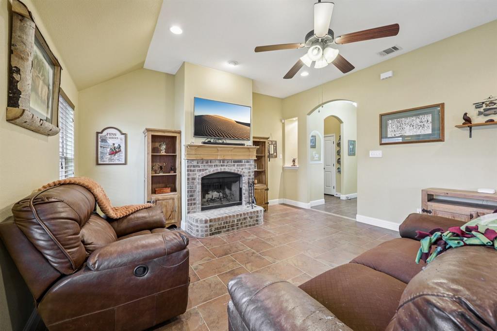 118 Kenya Court Springtown, TX 76082 - Photo 8 of 35 a living room with furniture and a fireplace