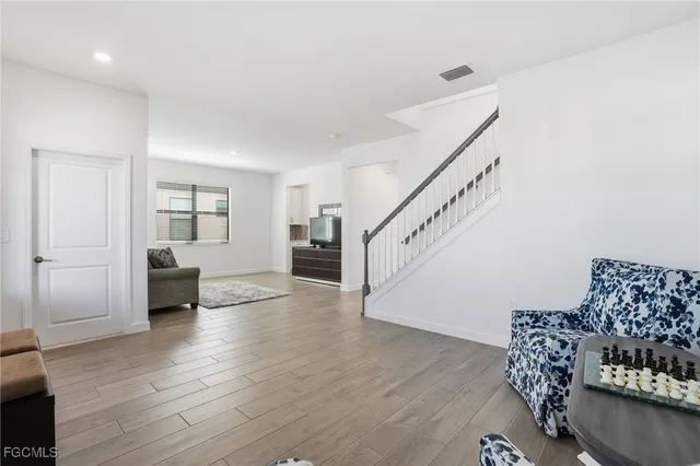 a living room with furniture and wooden floor