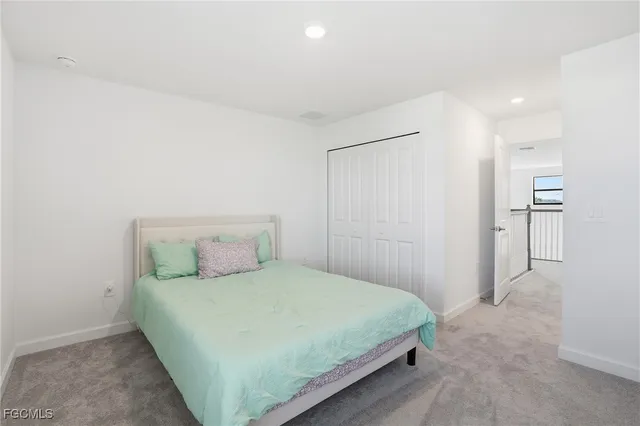 a bedroom with a bed and cabinets