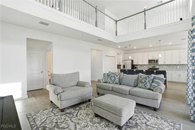 a living room with furniture and kitchen view